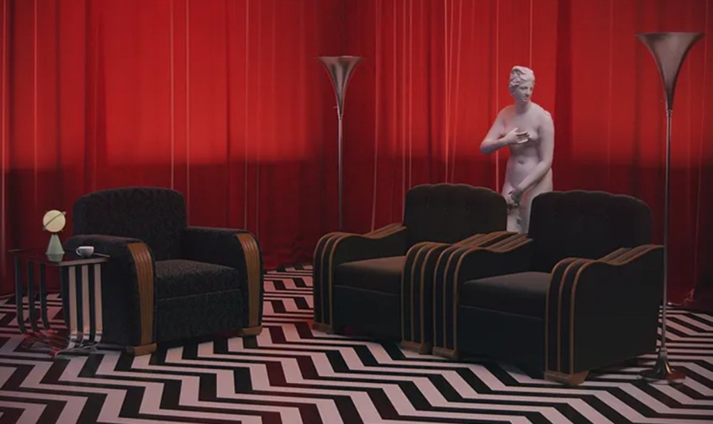 The Red Room — red curtains, zigzag floor, waiting-room chairs