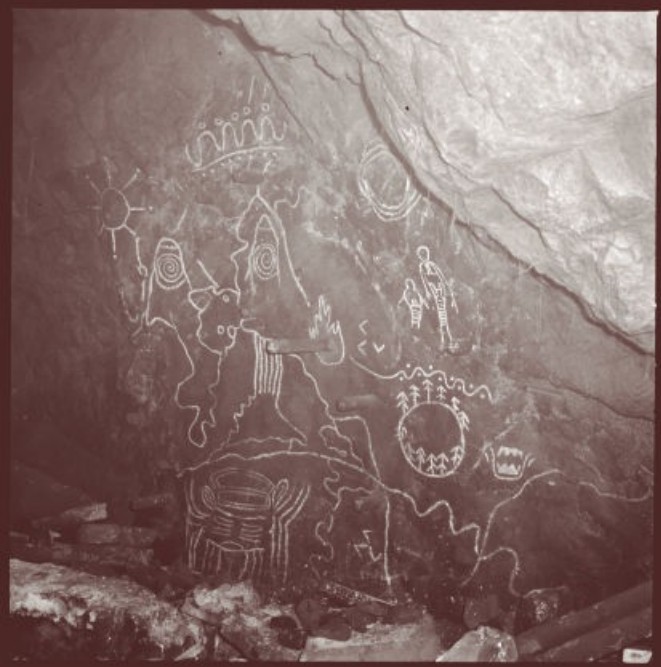 Owl Cave petroglyph map — owl figure, twin peaks, sun and moon, circle of trees on the cave wall