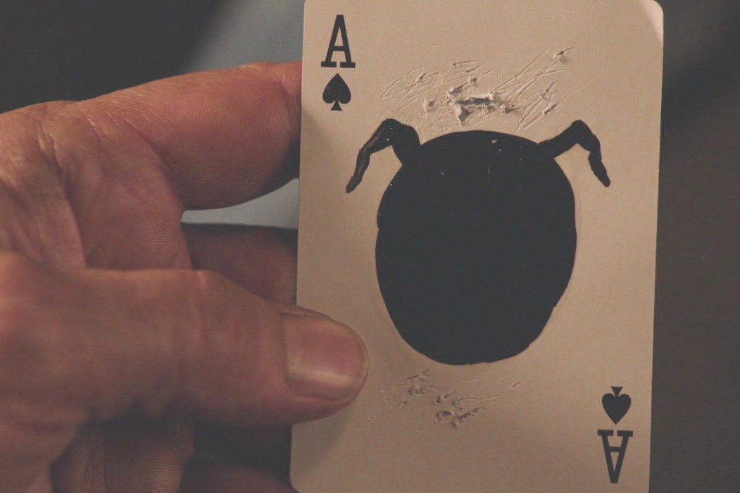 Scratched ace of spades — Owl Cave mark over the spade