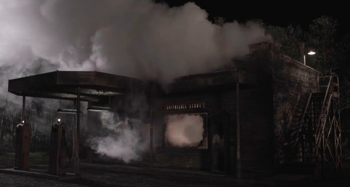 Convenience store at night — smoke pouring from the building, gas pumps under a canopy