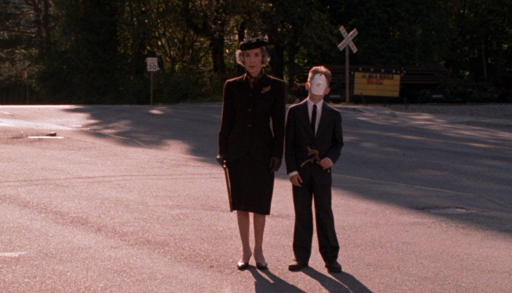 Mrs. Chalfont and her masked grandson standing in the road