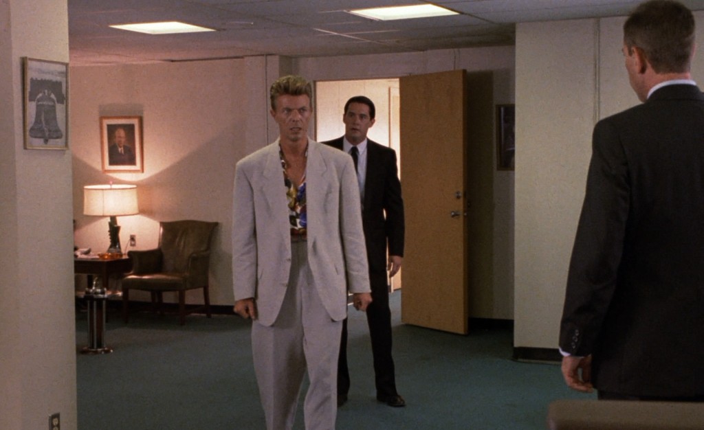Phillip Jeffries walking into the Philadelphia FBI office as Cooper watches from the doorway