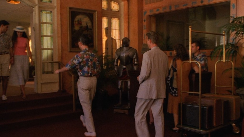 Palm Deluxe hotel lobby in Buenos Aires - Jeffries arrives with suitcase, armor and peacock on the wall