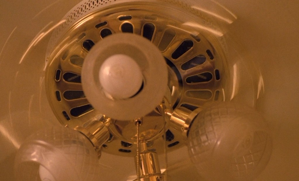 Looking up at the spinning brass ceiling fan on the Palmer house landing