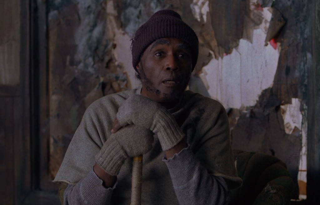 A Woodsman with beanie and staff in the room above the convenience store