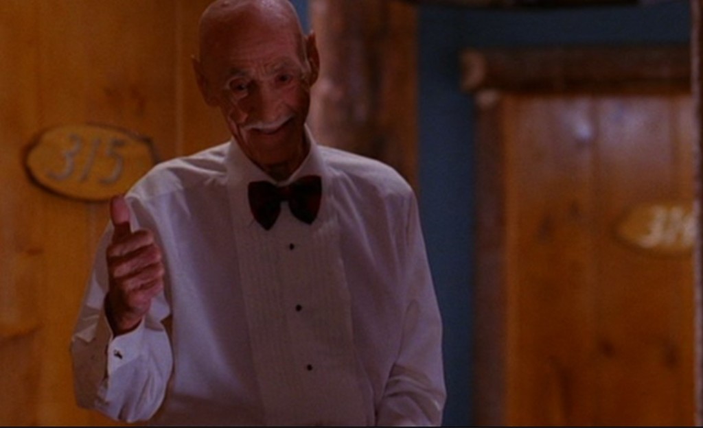 Elderly Great Northern waiter giving a thumbs-up outside room 315